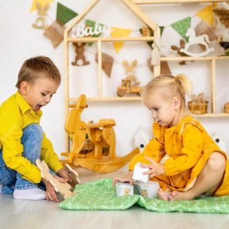 little-children-girl-with-boy-brace-with-sister-play-home-with-wooden-toys-stands-pyramid-tower-smiles-happy-childhood_267293-8301